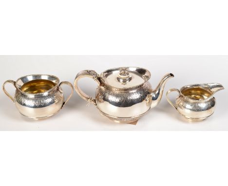 A Victorian three piece silver tea service of rounded, half-fluted form with beaded rims, each piece decorated with a band of