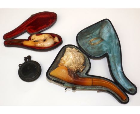 A Meerschaum pipe carved with the head of a girl, and a similar tiger carved cheroot holder, each cased, together with a coin