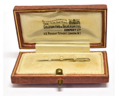 AN EARLY 20TH CENTURY WHITE GOLD AND SMALL PEARL THREE STONE BAR BROOCH  stamped '18ct', 31mm long overall, 0.8g gross, in a 