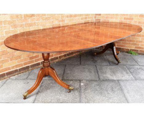 A REGENCY STYLE TWIN PILLAR MAHOGANY DINING TABLE  with two additional leaves, 272cm long fully extended (each leaf 54cm wide