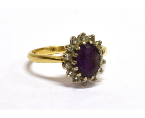 AN 18CT GOLD. AMETHYST AND DIAMOND OVAL CLUSTER RING centred with an oval mixed-cut amethyst within a small eight-cut diamond