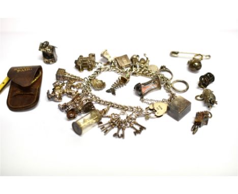 A COLLECTION OF JEWELLERY INCLUDING A SILVER CURB LINK 'CHARM' BRACELET  on a padlock clasp, Birmingham 1970, and hung with a