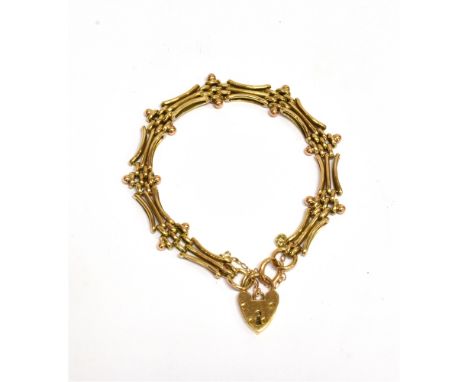 AN EARLY 20TH CENTURY GOLD FANCY THREE-BAR GATE BRACELET  with block inter-links, on a padlock clasp stamped '9ct', 11.7g  