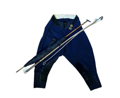 A pair of early 20th century riding or coachman's breeches in navy wool with a silk lined silk waistband, suede inner leg pat