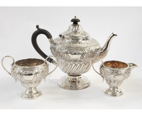 Victorian silver three-piece tea service, the top with engraved and embossed foliate decoration above the wrythen twist lower