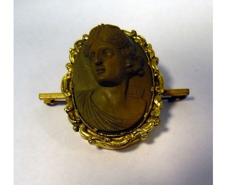 Victorian lava cameo brooch, oval with female classical head and shoulders portrait in relief and having gold-coloured rococo