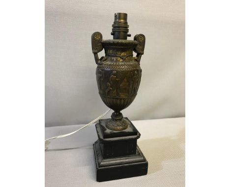 Heavy Bronze garniture Urn table lamp situated on a slate base 