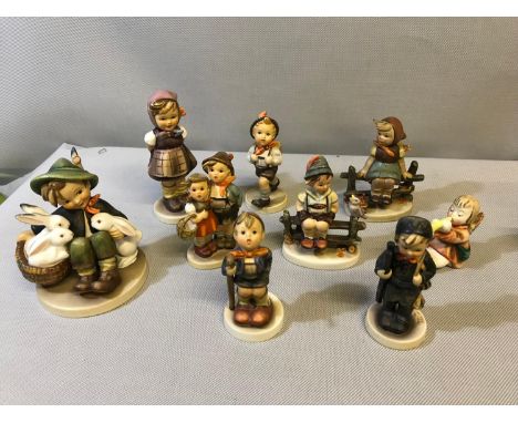 A Collection of Hummel boy and girl figures some are damaged 