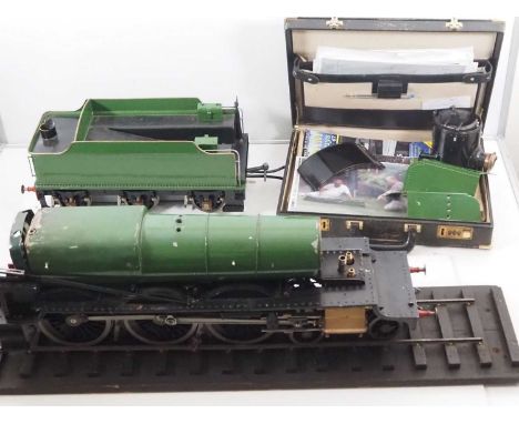 A 3.5 inch gauge 4-6-0 live steam Churchward Mogul steam locomotive in green livery, currently partly disassembled but appear
