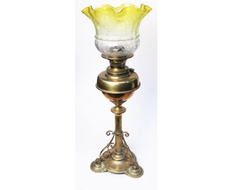 A brass oil lamp with etched yellow shade. H65cm (damaged)