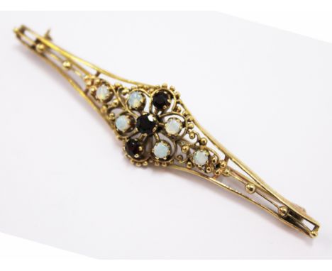 A 9ct gold opal and garnet brooch. L8cm Wt.9.1g