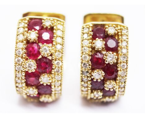 A pair of 14k gold diamond and ruby earrings. Gross wt. 10.8g