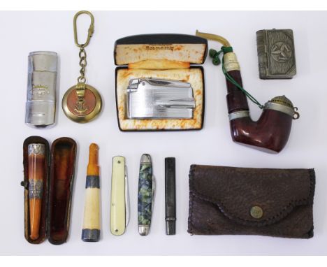 A mixed lot to include a pipe, two amber and Meerschaum cheroot holders, penknives, a lighter etc.