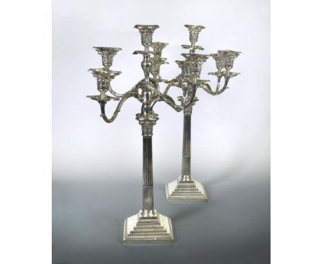 A pair of George V silver four branch five light metamorphic candelabra, by William Hutton &amp; Sons, Sheffield 1923, the ce