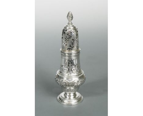 A George III silver sugar caster, by John Delmester, London 1764, of baluster form with repoussé decorated body, the pierced 