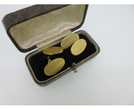 A pair of 18ct gold double ended cufflinks, the oval flat plaques all with engine turned decoration, chain connectors, Birmin