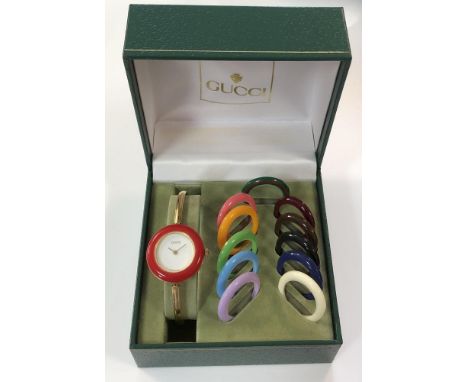 Gucci - A lady's gold plated bangle watch, circa 1994 - model 11/12.2, the signed circular white dial with gold coloured hand