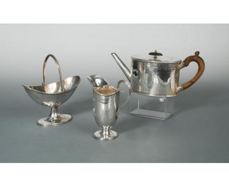 A Victorian silver three piece tea set, by Robert Harper, London 1874, the teapot of straight sided oval form decorated with 