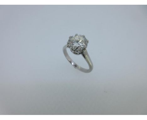 A single stone diamond ring, the round brilliant cut diamond eight claw set to a heart gallery and plain tapered shank size K
