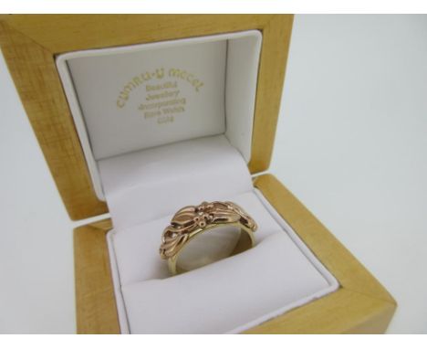 Clogau - A 9ct rose and yellow gold 'Tree of Life' band ring, the pierced rose gold front, which, according to the current Cl