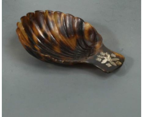 A 19th Century pique tortoiseshell caddy spoon, modelled as an open scallop shell, the thumbpiece decorated with pique petals