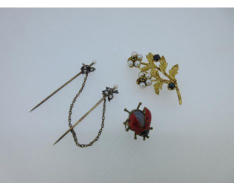 A gold and gem set spray brooch, together with diamond and seed pearl cloakpins and a ladybird buttonhole, the two flowers of