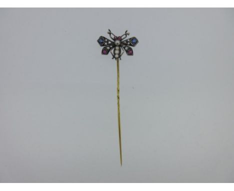 An antique diamond and gem set butterfly stick pin, the butterfly with a rose cut diamond thorax, graduated half seed pearl (