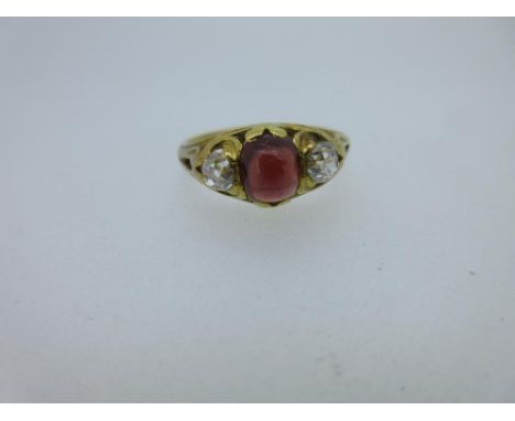 An early Victorian diamond and spessartine garnet three stone ring with 1841 memorial inscription inside, the cushion shaped 