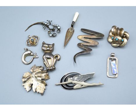 A 925 Silver Brooch in the Art Deco Style depicting a Winged Figure with enamel together with various other silver and relate