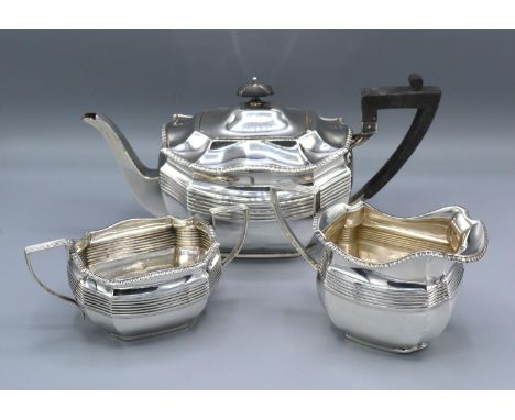 A George V Three Piece Tea Service comprising teapot, cream jug and two handled sucrier Sheffield 1914 retailed by James Dixo