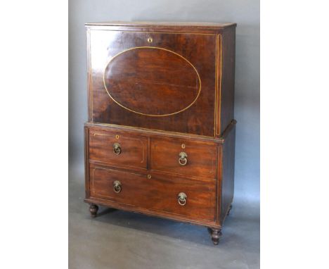 A Regency Mahogany Cabinet on Stand, the fall front enclosing a fully fitted interior with walnut drawers and pigeon holes ab