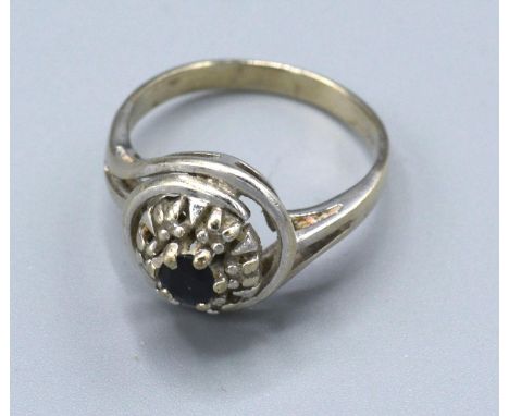 A 14ct. White Gold Diamond and Sapphire Cluster Ring with a central sapphire surrounded by diamonds, 3.6 gms. ring size O 