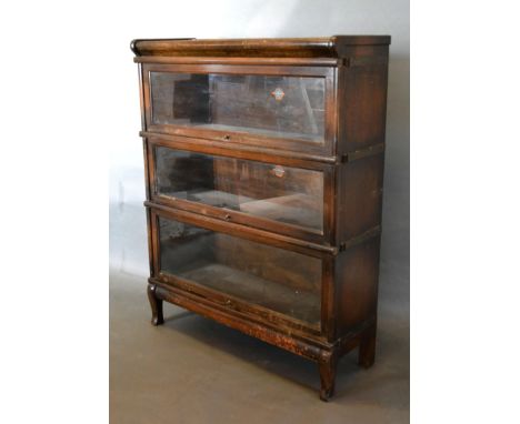 An Early 20th Century Oak Globe Wernicke Three Section Glazed Bookcase raised upon shaped feet, 87cms wide, 31cms deep, 110cm