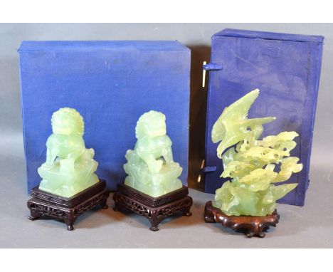 A Chinese Jade Carving with hardwood stand and fitted box together with another similar pair of Chinese jade dogs of fo with 