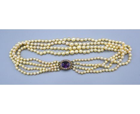A Cultured Graduated Pearl Four Strand Choker, the yellow metal clasps set with an amethyst surrounded by pearls 