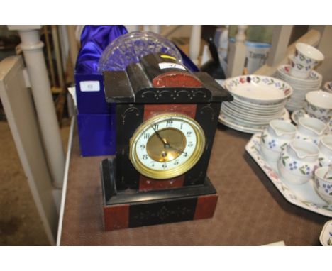 A black slate and rouge marble single hole mantel clock 