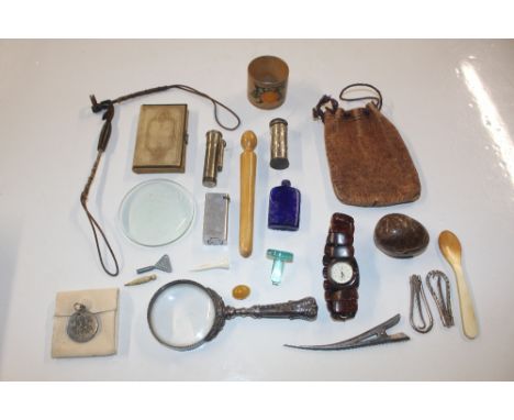 A box containing magnifying glass, lighter, wrist watch, hardstone egg etc.