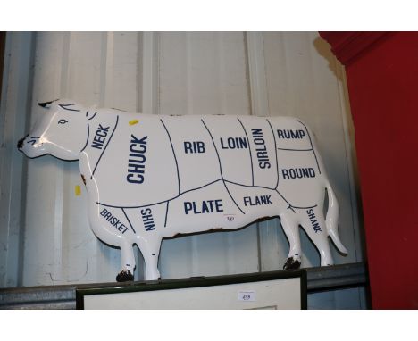 An enamel cow sign