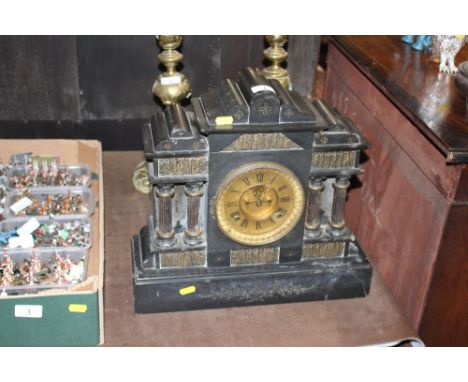 A late Victorian black slate two hole mantel clock decorated with Corinthian columns and panel depicting classical figures 