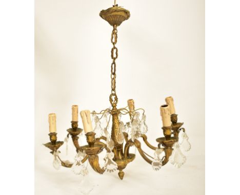A continental inspired early 20th century 1920s style gilded solid brass six arm ceiling chandelier. The ceiling light having
