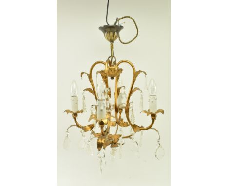 A 20th century gilt metal Italian inspired toleware four branch chandelier ceiling light. The chandelier featuring four branc