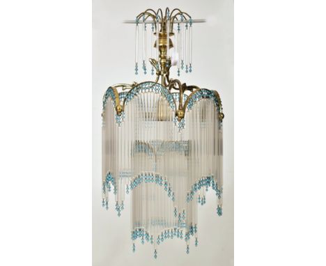 An Art Deco inspired 20th century gilt metal &amp; glass rod ceiling chandelier light. The chandelier having a scrolled sunbu