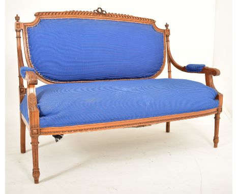 A French Louis XVI style 20th century carved oak &amp; upholstered two seater canape sofa. The sofa having an intricately car