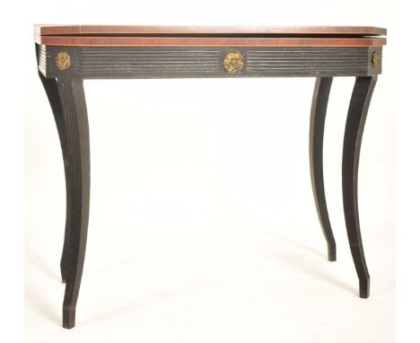 A 19th century Louis XV inspired mahogany and ebonised wood card folding table. The table having a folding inlaid top with ca