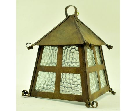 An early 20th century Arts &amp; Crafts hanging porch lantern lamp light. The light of copper construction having a pyramidal