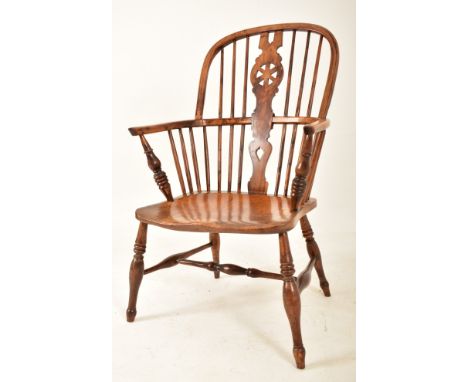 A Victorian 19th century yew wood, elm &amp; beech wood Windsor comb back armchair. The chair having a comb two tier back res