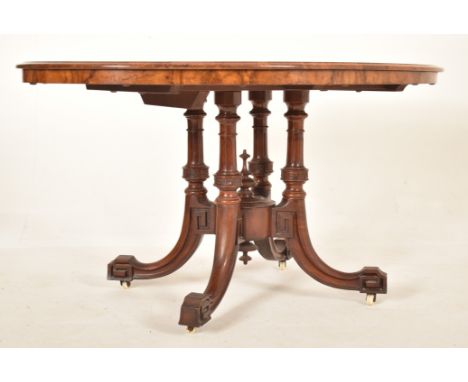 A 19th century High Victorian walnut oval tilt top loo / breakfast table. The table being raised on splayed legs with inverte