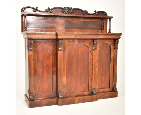 An early Victorian 19th century flame mahogany breakfront chiffonier cabinet. The chiffonier with embellished carved gallery 