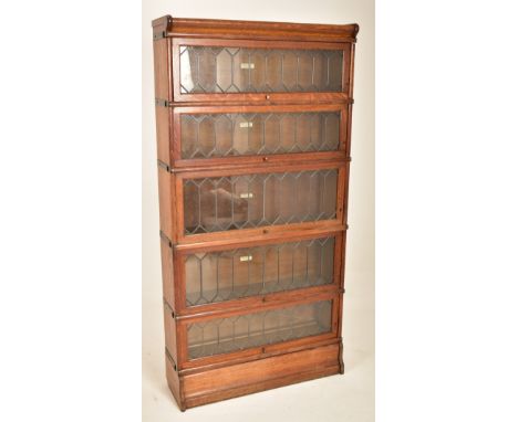 Globe Wernicke - An early 20th century oak five section stacking lawyers bookcase. The bookcase having a pediment atop over t