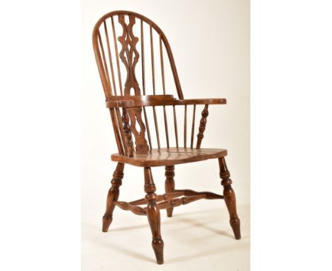 A late Victorian late 19th century beech &amp; elm comb back Windsor armchair. The chair having&nbsp;a comb two tier back res